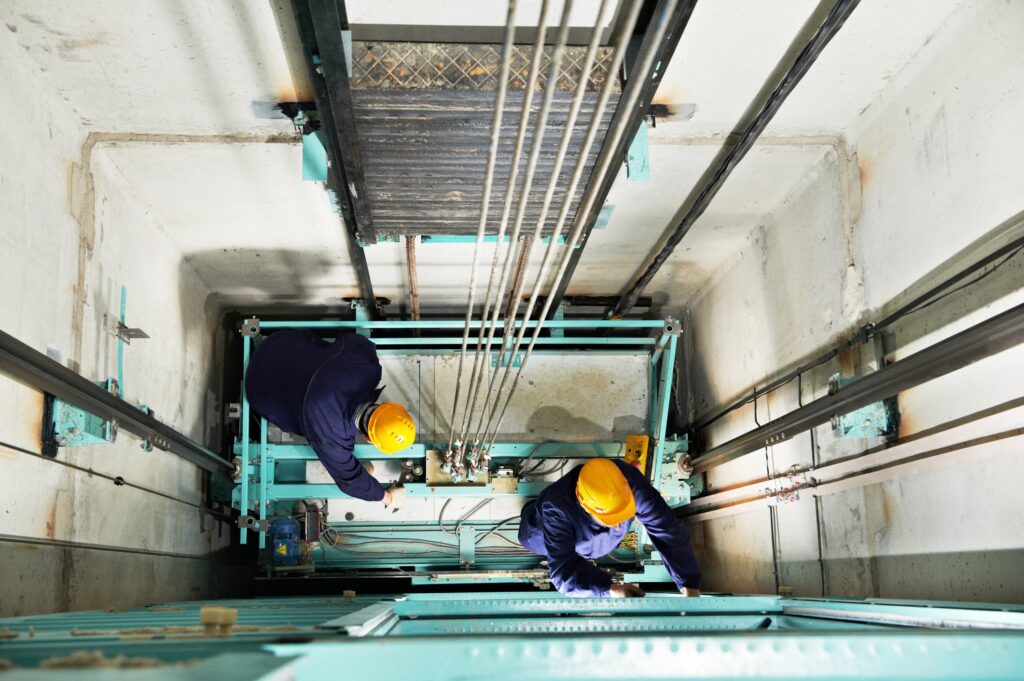 technicians-in-elevator-shaft